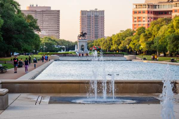 People walking around Hermann Park on a sunny afternoon
