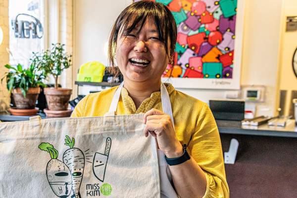 Chef Ji Hye Kim stands inside of Miss Kim