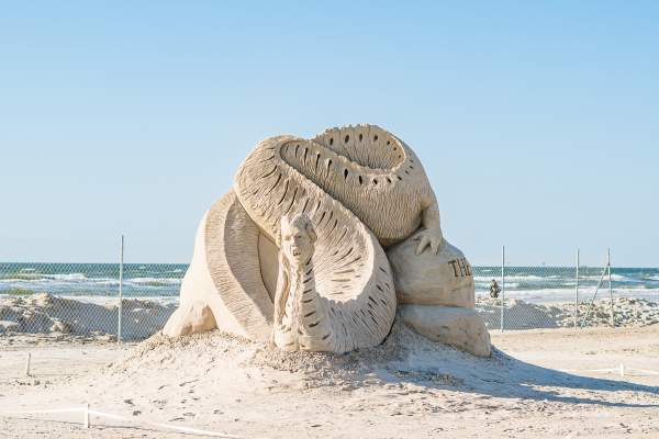 Sand sculpture of a sea serpent-type monster with a human woman head