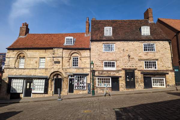 Exterior of Jew's House on Steep Hill in Lincoln with blue sky