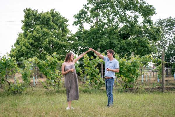 Couple dancing in front of grape vines at Totem Pole Ranch & Winery