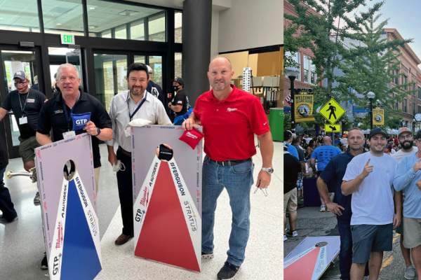 Group of men standing with corn hole game boards