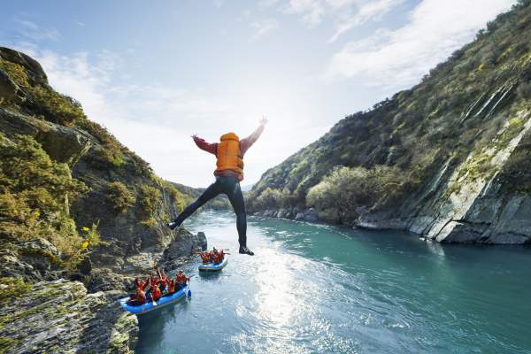 Rafter jumps into water during white water rafting trip
