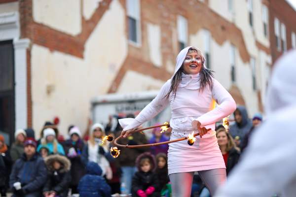 woman fire dancer performing at outdoor winter festival