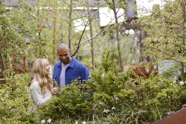 2 people surrounded by greenery at Castlefield Viaduct