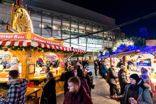 Christmas Markets at night with people in Exchange Square, Manchester