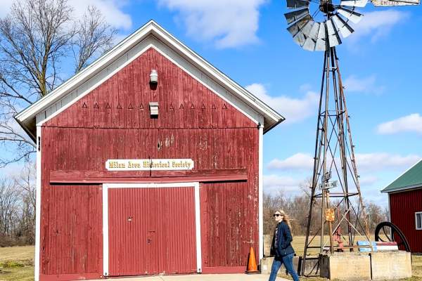 walking in front of historic barn in Milan, MI