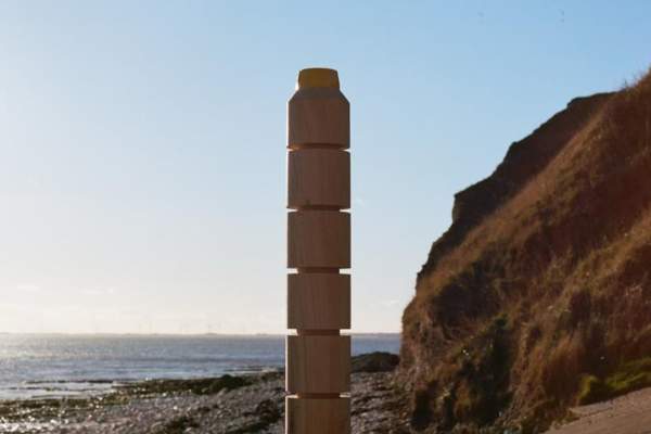 An active beacon post overlooking the rugged coastline an sea.