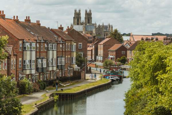A couple taking a stroll along Beverley Beck with the Minster in the background.