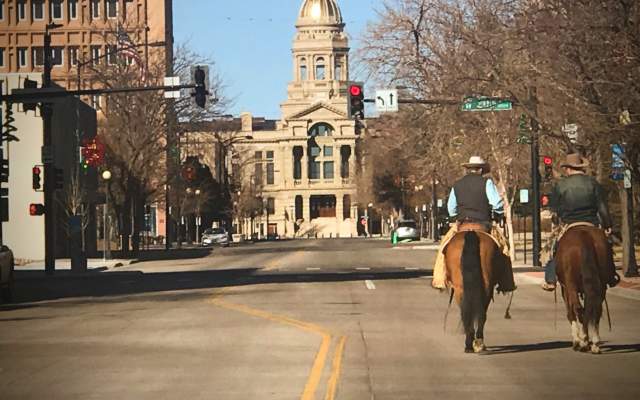 Cheyenne, Wyoming State Capitol behind the Old West Holiday Pony Express Riders on horseback
