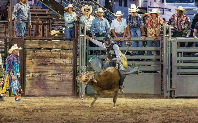 A cowboy rides a bull at the Hell on Wheels rodeo
