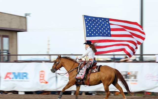 Shelby riding with flag