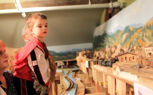 Young boy looks curiously at the model trains at the Cheyenne Depot Museum.