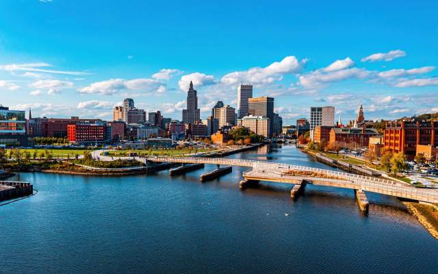 The Providence River Pedestrian Bridge spanning the Providence River with the Providence skyline in the background.