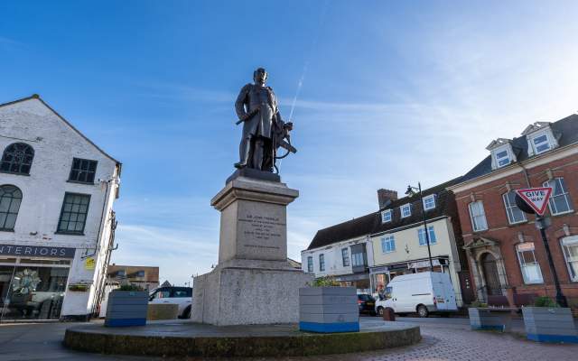 a statue of Sir John Franklin in Spilsby town under blue skies