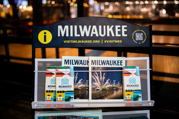 A display of Visit Milwaukee collateral including official visitors guides and maps.