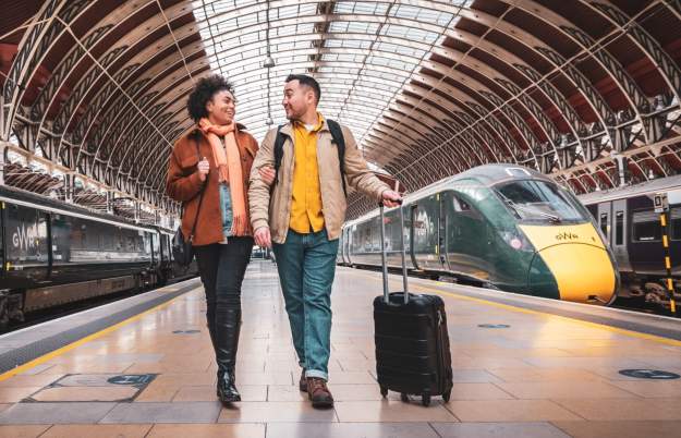 Couple walking on platform at train station