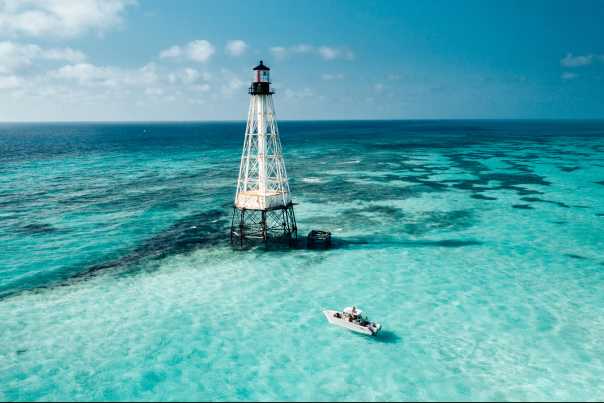 A boat anchors for snorkelers near Alligator Reef Light to enjoy the brilliant clear waters off Islamorada in the Florida Keys.