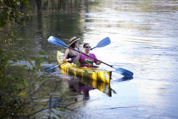 Two women paddle a canoe on the Peace River near Arcadia in Central Florida
