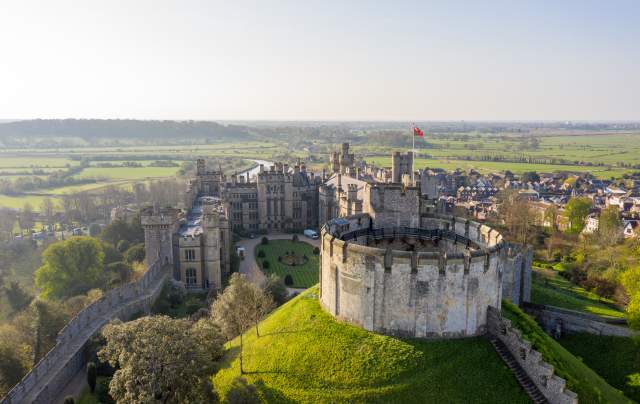 Aerial view of the keep at Arundel Castle with Arundel and fields in the distance