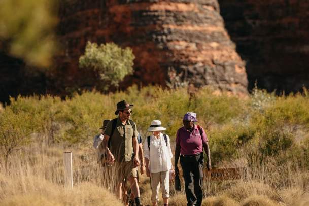 A guide from Kingfisher Tours takes a couple through the striped domes of the Bungle Bungle Ranges