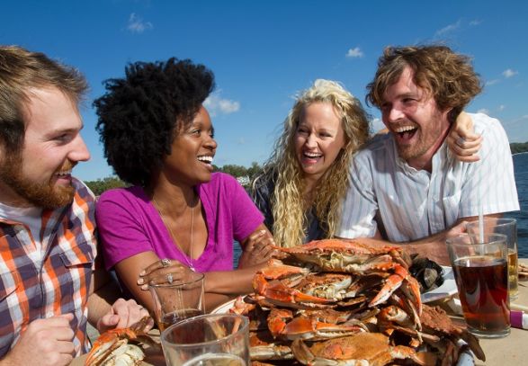 Friends gather for a crab feast by the water