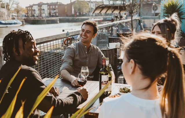 Friends drinking wine on the terrace at Harbour House
