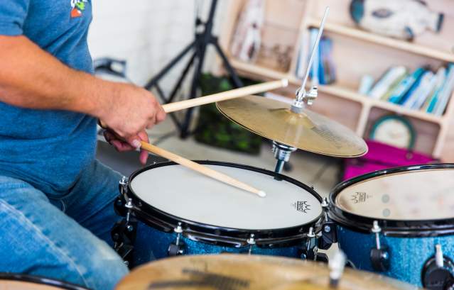 A close up of a man drumming.