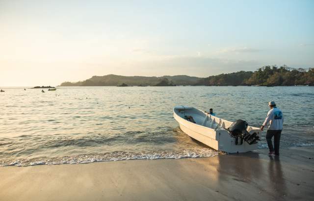 A small fishing boat in the shores of a calm beach at Cerro Hoya