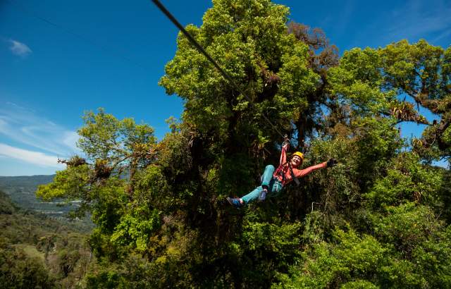 Visitor on a zip line crossing the sky at a park in Boquete, Chiriquí province, Panama