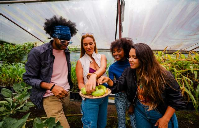 Friends tasting freshly harvested vegetables in Hacienda Mamecillo, Boquete, Chiriqui Province, Panamá