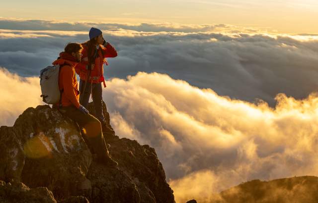 Couple at sunset in the top of Baru Volcano. At the background you can see huge clouds