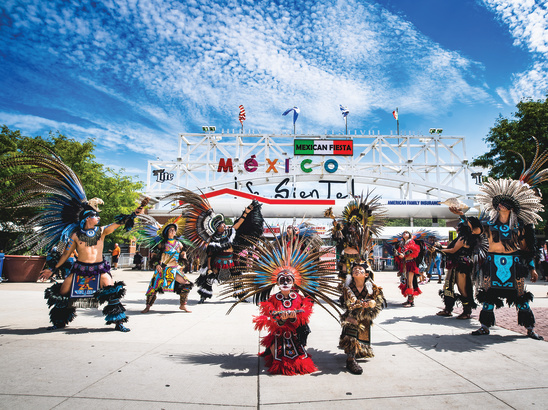 traditional Mexican dance in front of Mexican Fiesta festival grounds main gate