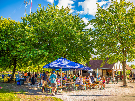 picnic tables filled with people in park