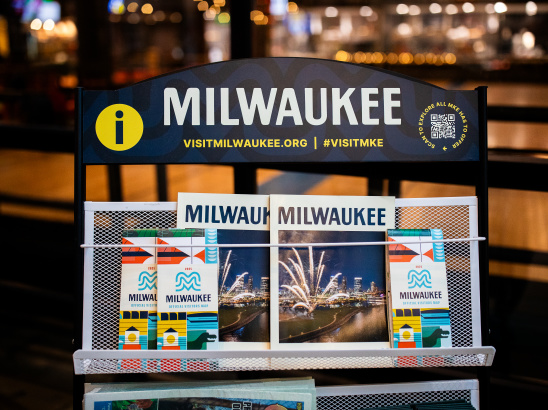 A display of Visit Milwaukee collateral including official visitors guides and maps.