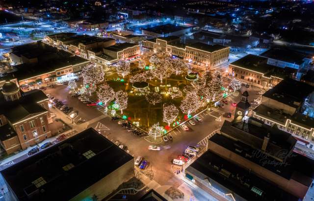 Drone photo of the Woodstock Square at night during the holidays.