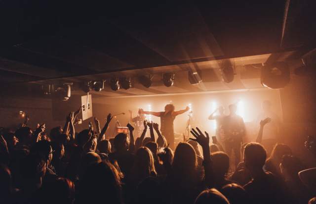 Band performing on stage in front of a crowd