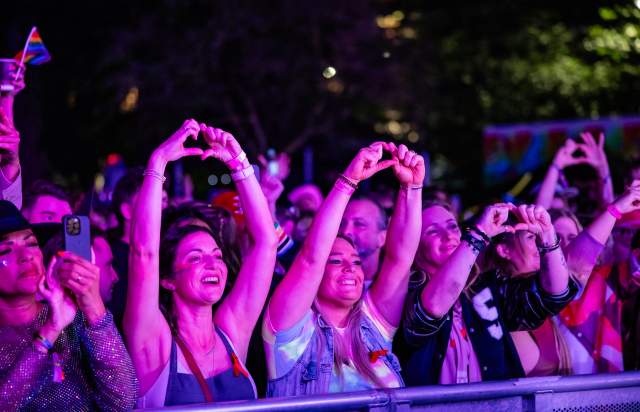 Crowd making hearts with hands at Manchester Pride