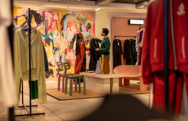 people looking at clothes in a shop in Manchester