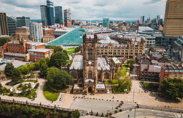 Cathedral in Manchester city centre with cityscape in the background
