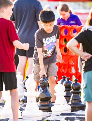 Youth Playing Chess at Starlight Cinema event