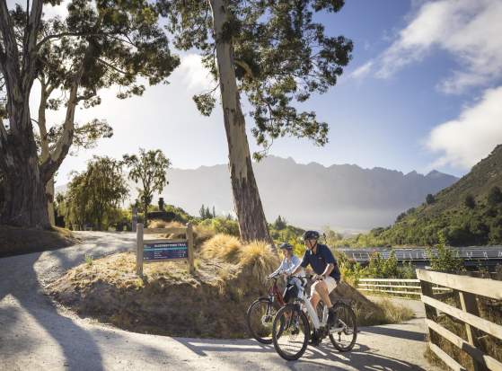 People biking with mountain in the background
