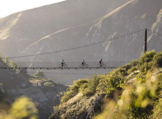 Group of three biking across Edgar Bridge