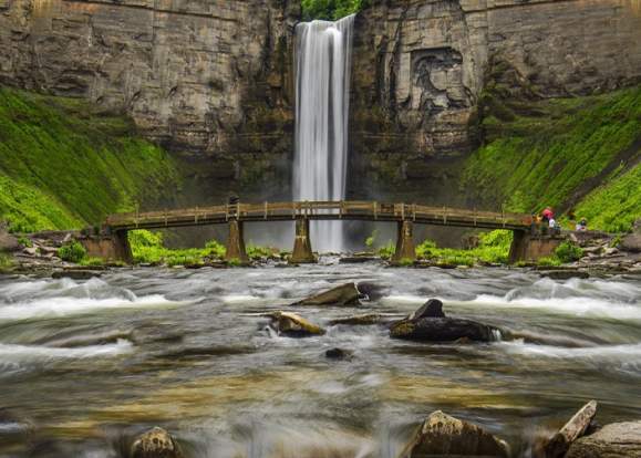 bridge in front of waterfall