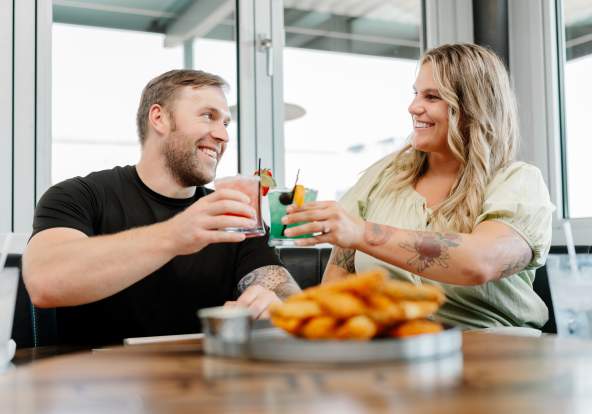 couple toasting before dinner at a restaurant