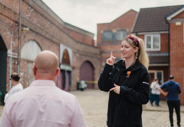 Guide on Coronation Street Tour set with visitors