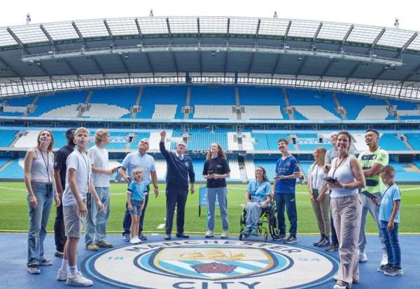 Group of fans inside football stadium on a tour