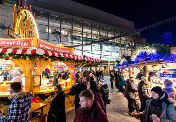 Christmas Markets at night with people in Exchange Square, Manchester