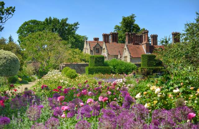Pretty flower beds and manor house at Borde Hill Garden, Sussex