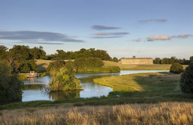 A view across the lake and deer park towards Petworth House in Sussex